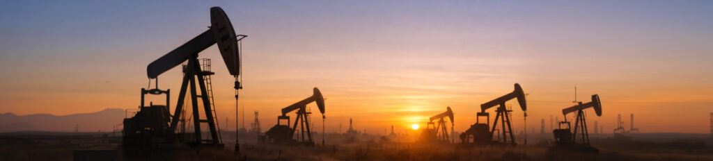 Wide banner showing oil production assets with article title overlay about understanding energy cycles.